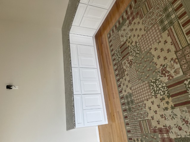 L-shaped base cabinets with granite countertop